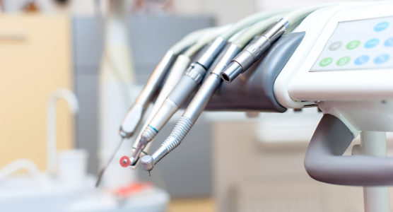 Dental tools on dentist chair with medical equipment and new technology